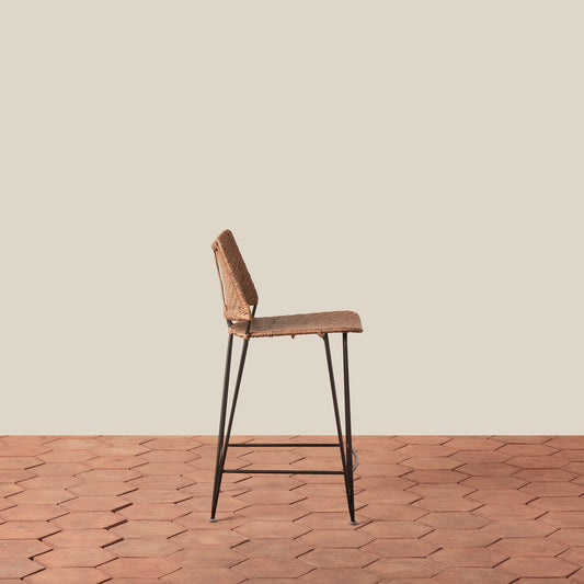 Bar stool with wicker seat and metal legs on a wooden floor. - Image 2
