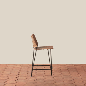 Bar stool with wicker seat and metal legs on a wooden floor. - Number 2