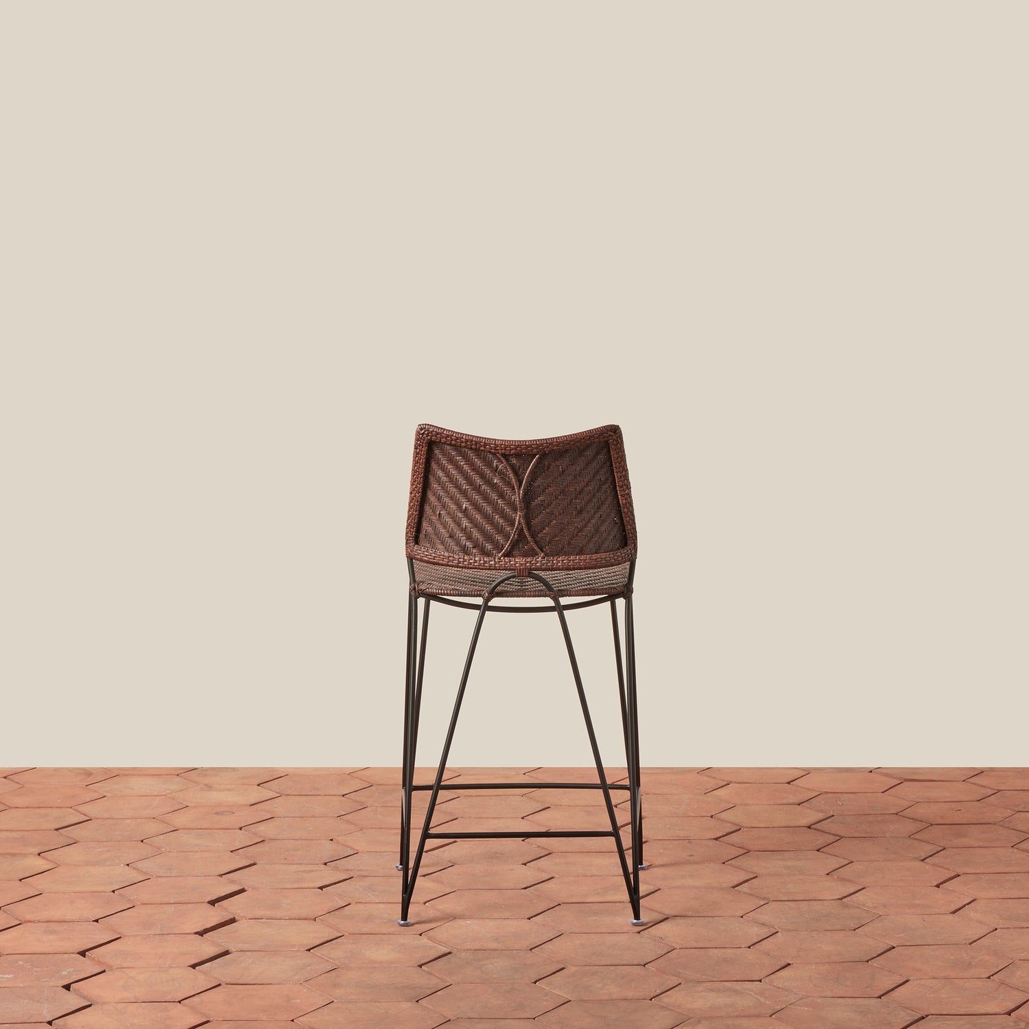 Bar stool with woven backrest on a wooden floor and beige wall- Number 10
