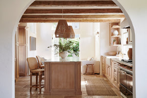 brown pendant lights hanging in kitchen above island with counter stools next to it - Number 2