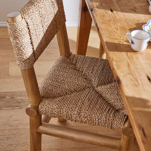 Wooden chair with woven backrest and seat next to a wooden table. - Number 3