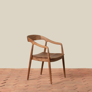 Teak arm chair on tile floor against beige background - Number 1