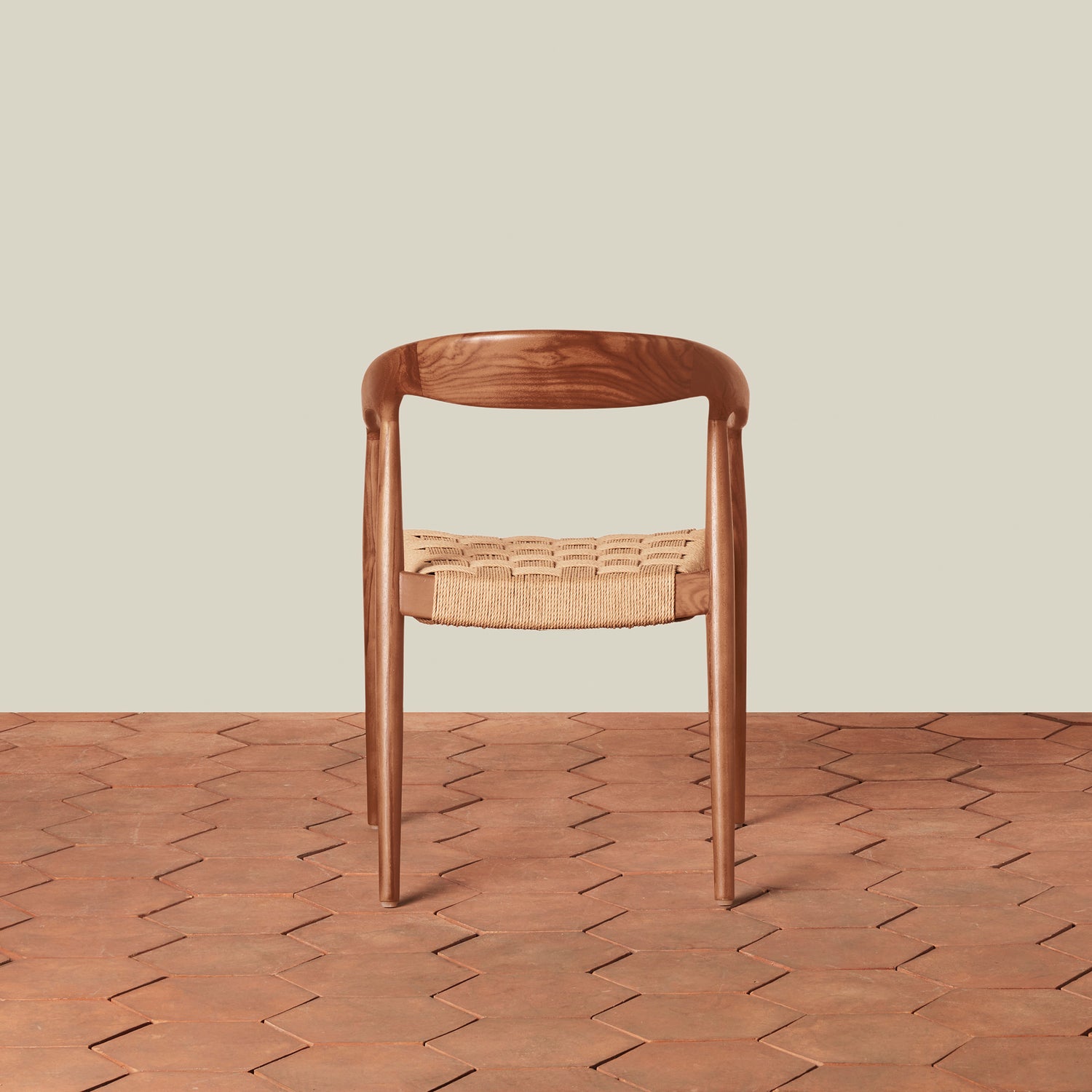 Wooden chair with woven seat on a wooden floor and beige wall background- Number 4