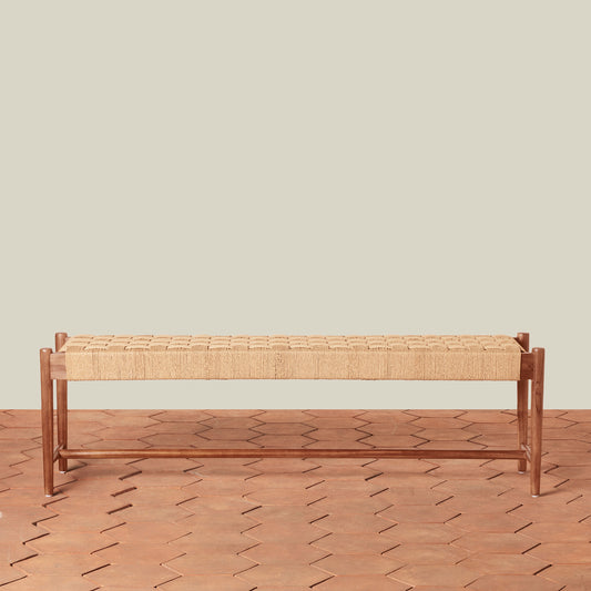 Wooden bench with woven seat on a wooden floor against a beige wall - Image 2