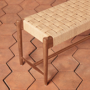 Wooden stool with woven seat on a hexagonal tile floor - Number 4