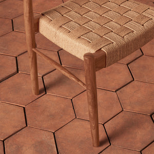 Wooden stool with woven seat on a hexagonal tile floor - Number 8