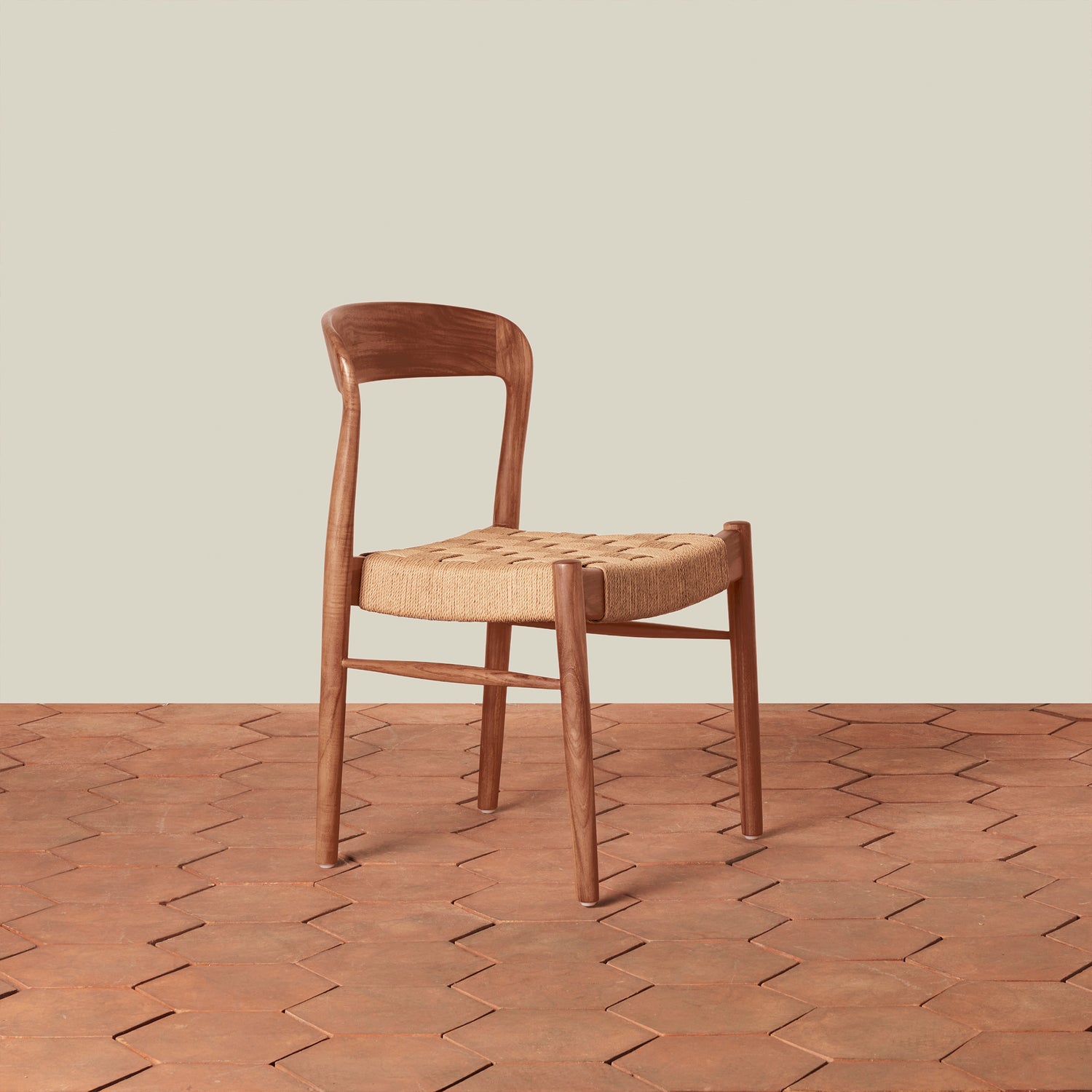 Wooden chair with woven seat on a wooden floor and beige wall background- Number 1