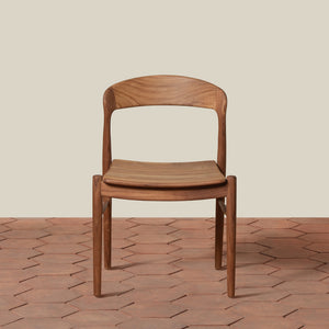 Wooden chair on a textured floor with a neutral background - Number 3