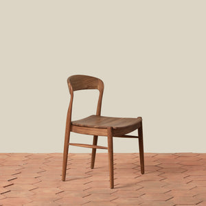Brown side chair on tiled floor against beige background - Number 1