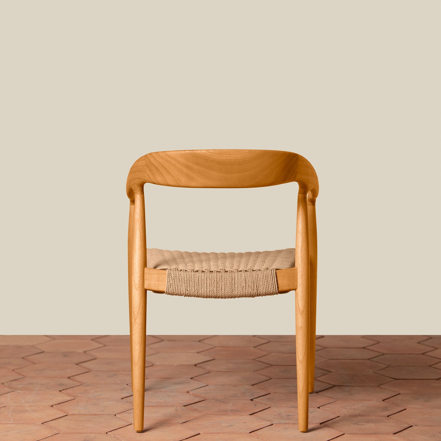 Wooden chair with woven seat on a wooden floor and beige wall background- Number 19