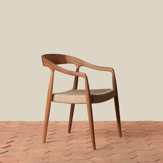 wooden arm chair on tile floor against gray background