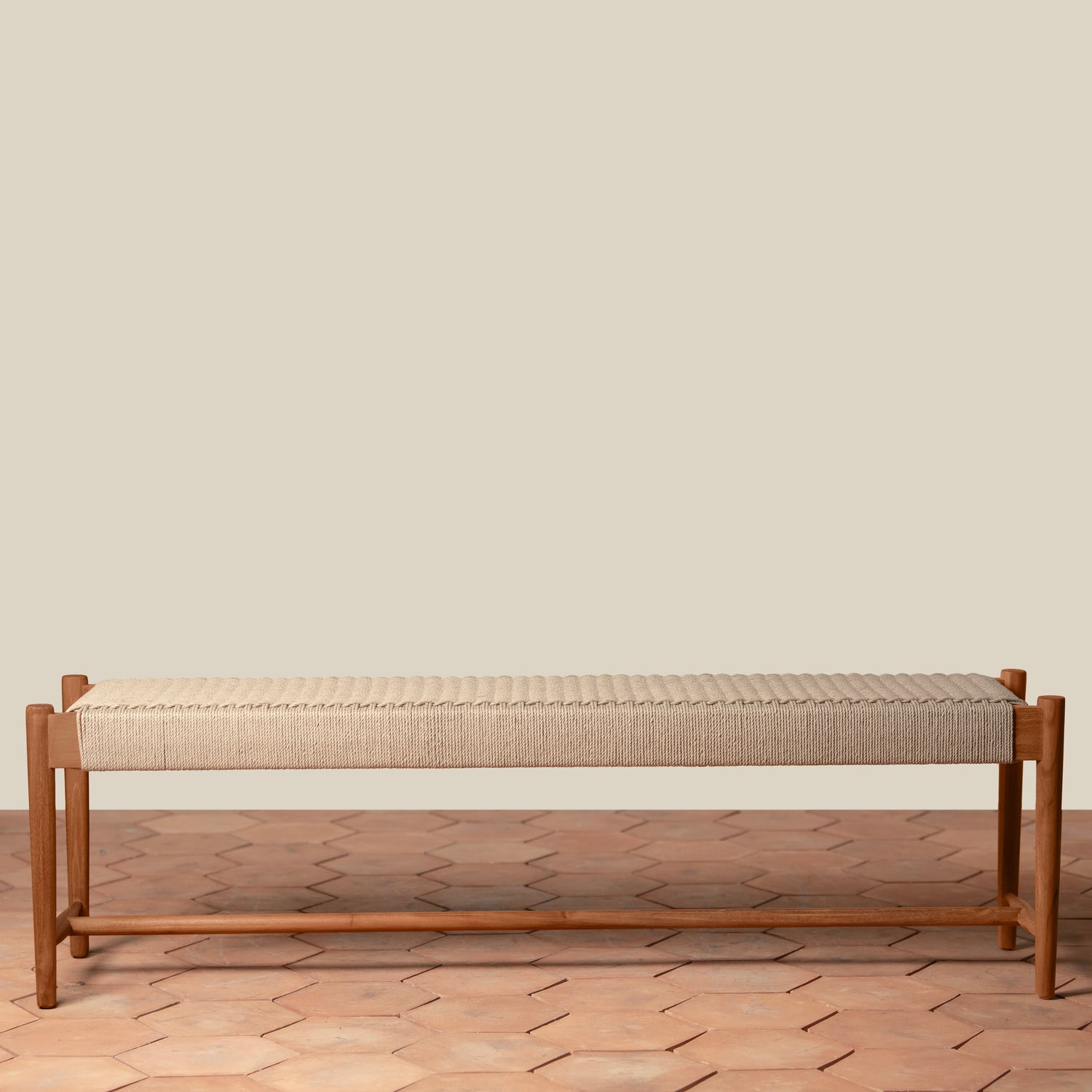 Wooden bench with woven seat on a wooden floor and beige wall background- Number 2