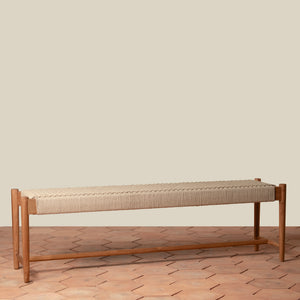 Wooden bench with woven seat on a wooden floor against a beige wall - Number 1
