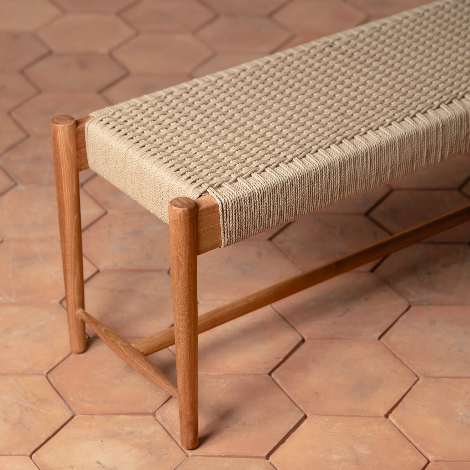 Wooden bench with woven seat on a terracotta tiled floor- Number 4