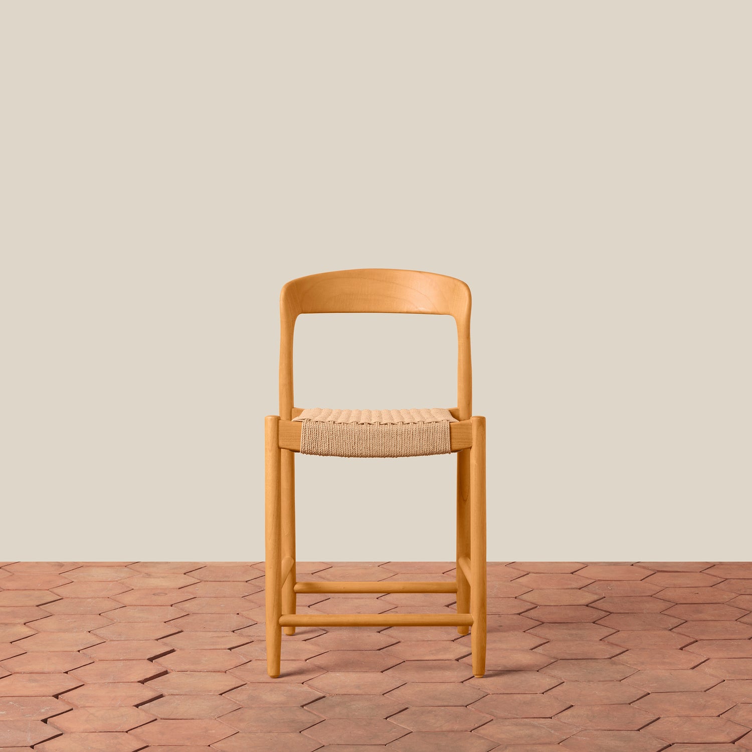 Wooden chair with woven seat on a wooden floor and beige wall background- Number 3