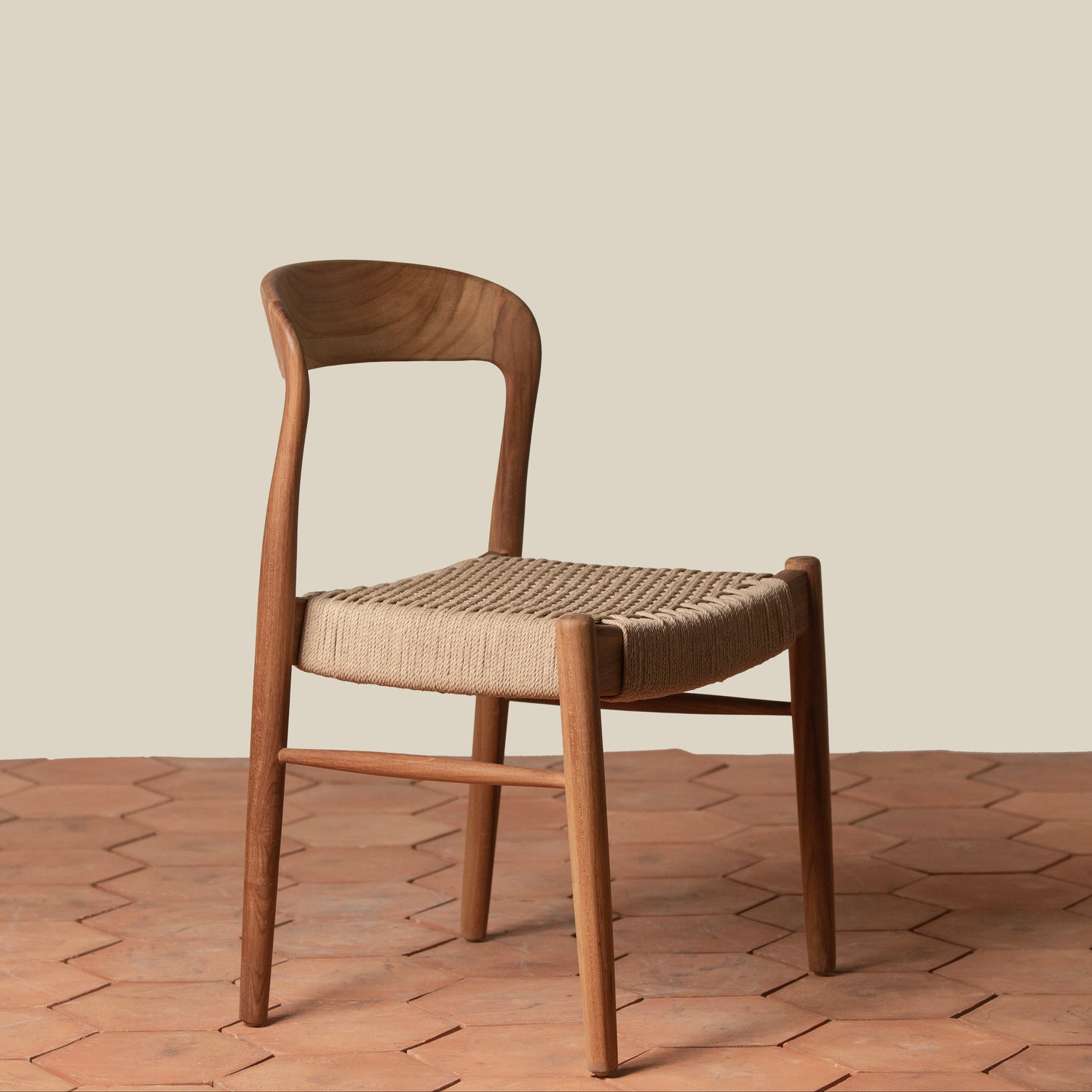 Wooden chair with woven seat on a wooden floor and beige wall background- Number 1