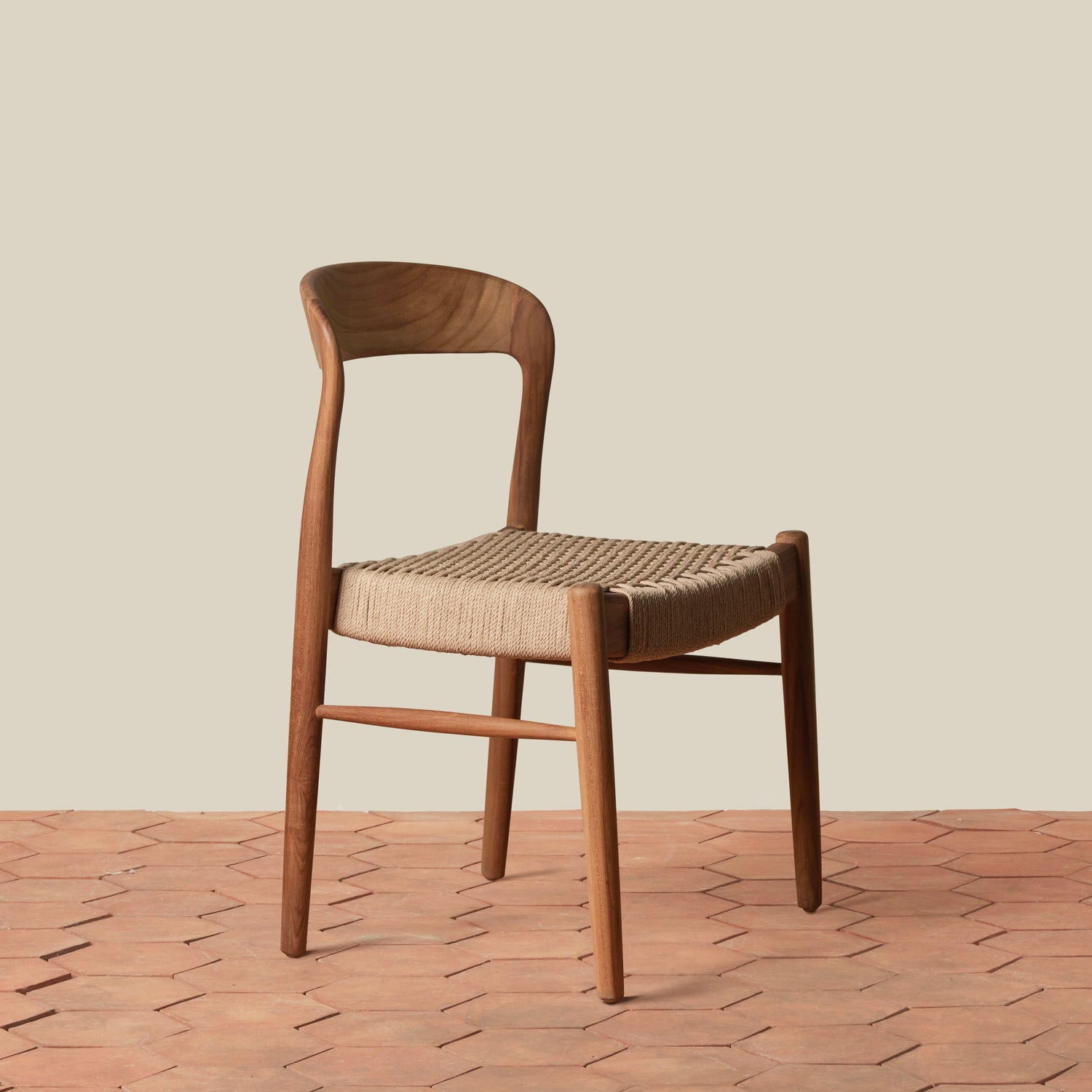 Wooden chair with woven seat on a wooden floor and beige wall background- Number 1