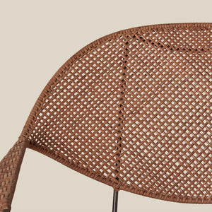 close up of brown rattan chair back against white background - Number 6