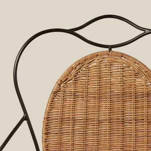 Close-up of a woven rattan chair back with a black metal frame against a solid beige background. - Number 7