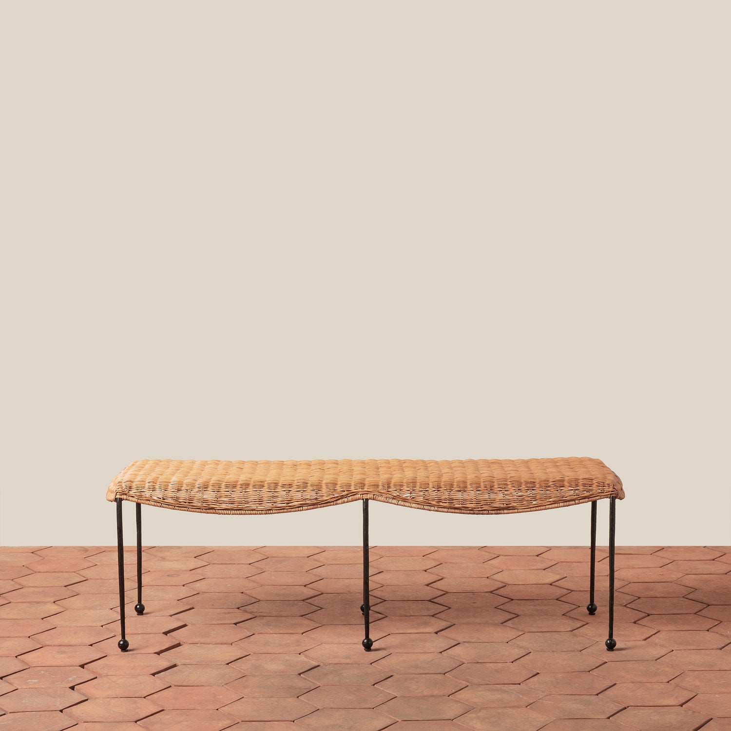 Woven bench on a wooden floor with a beige wall background- Number 2