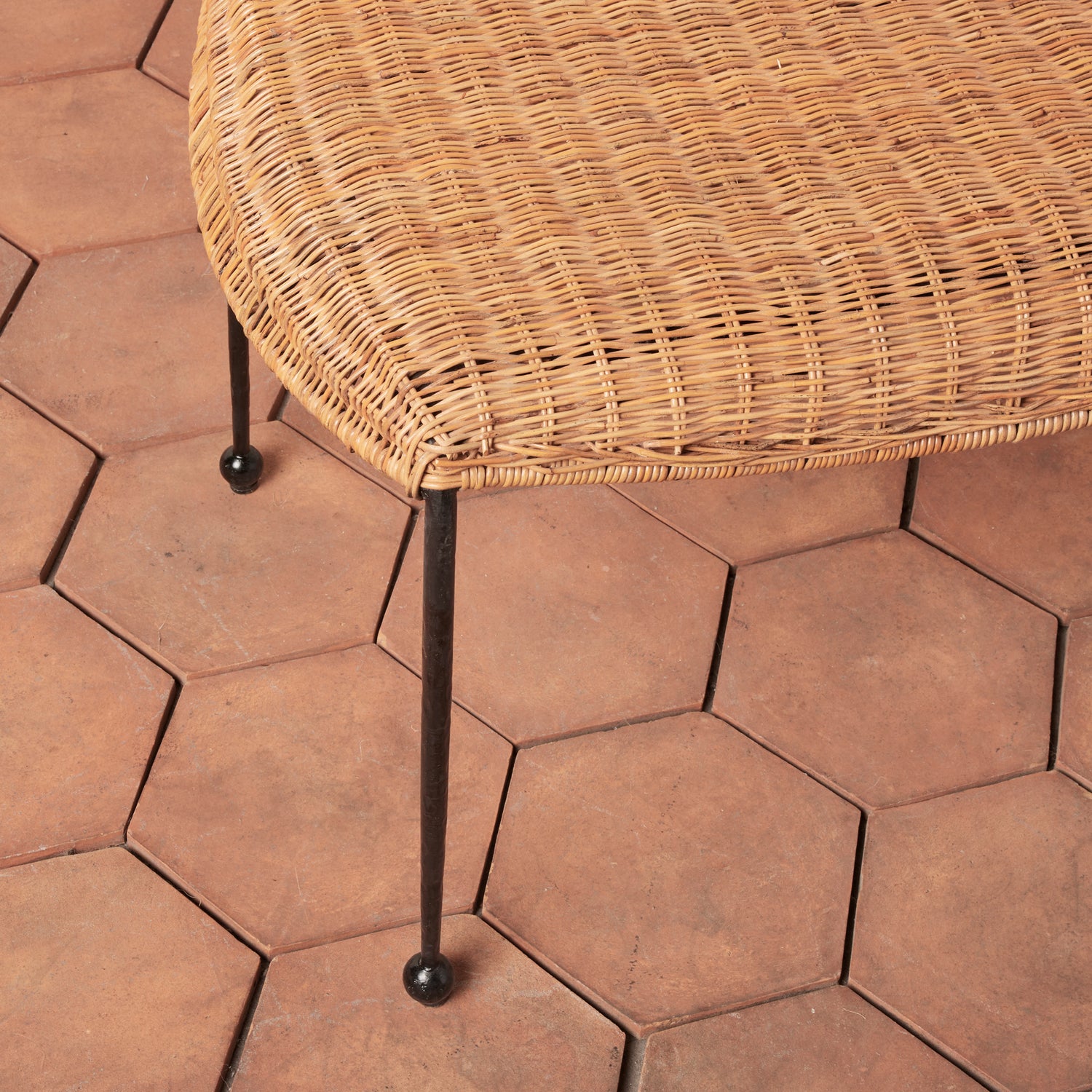 Hexagonal stone tiles with a wicker chair on a patio- Number 3