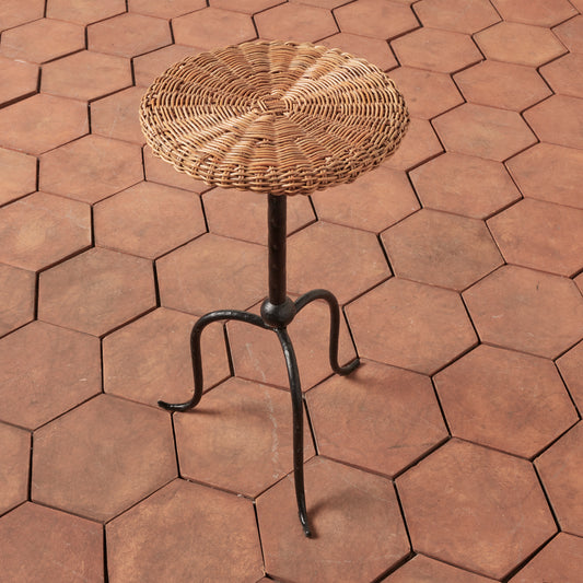 Wicker stool on a hexagonal brick-patterned patio - Image 2