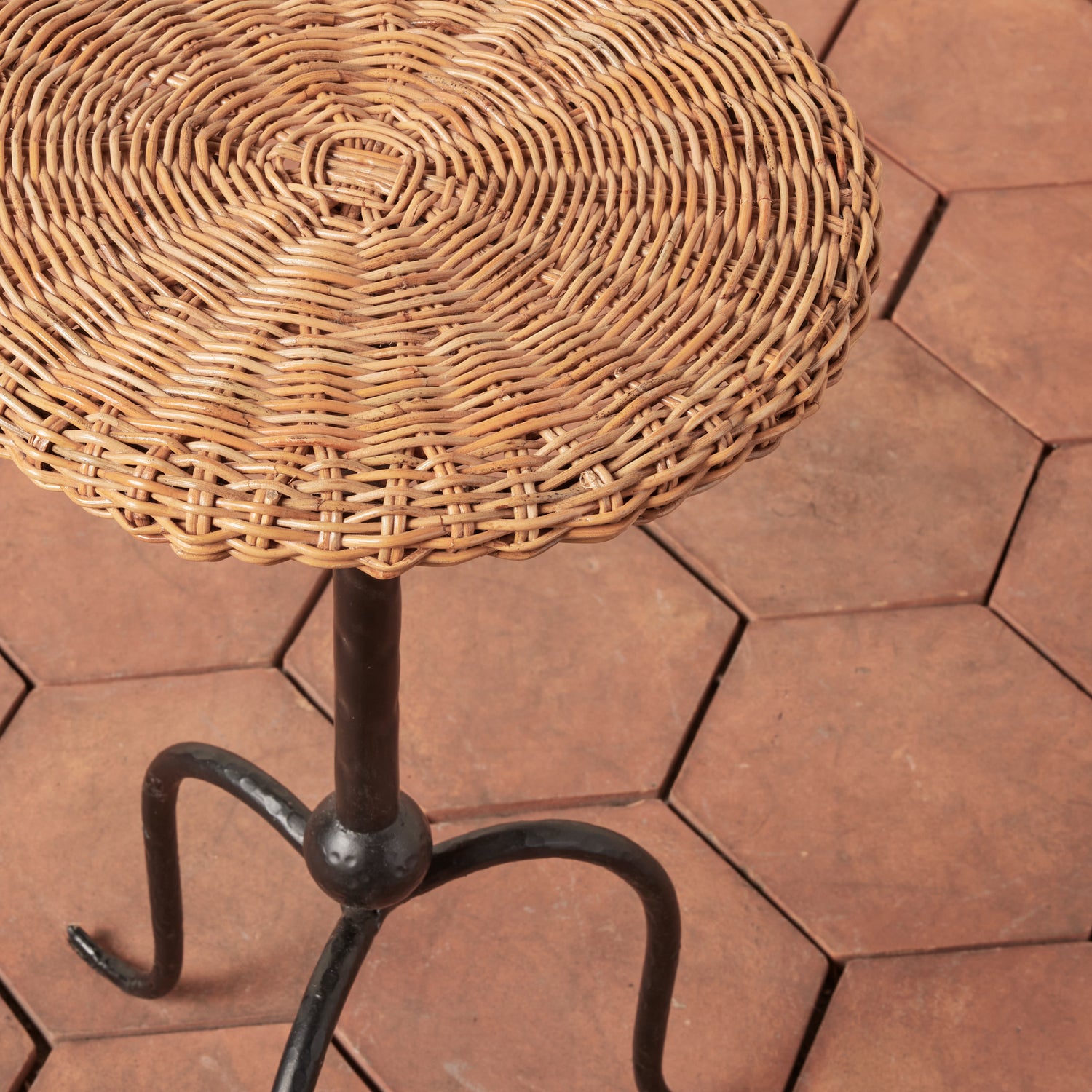 Wicker table with metal legs on a hexagonal stone patio- Number 3