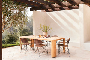 Outdoor dining area with a wooden table and chairs under a pergola. - Number 2