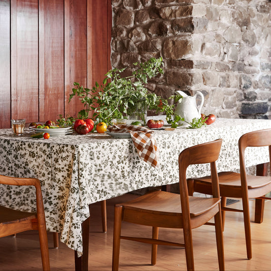 wood chairs at table setting, with greens and tomatoes on top of table - Image 2