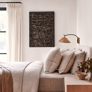 Neatly made bed with pillows and a lamp in a bedroom setting - Number 2