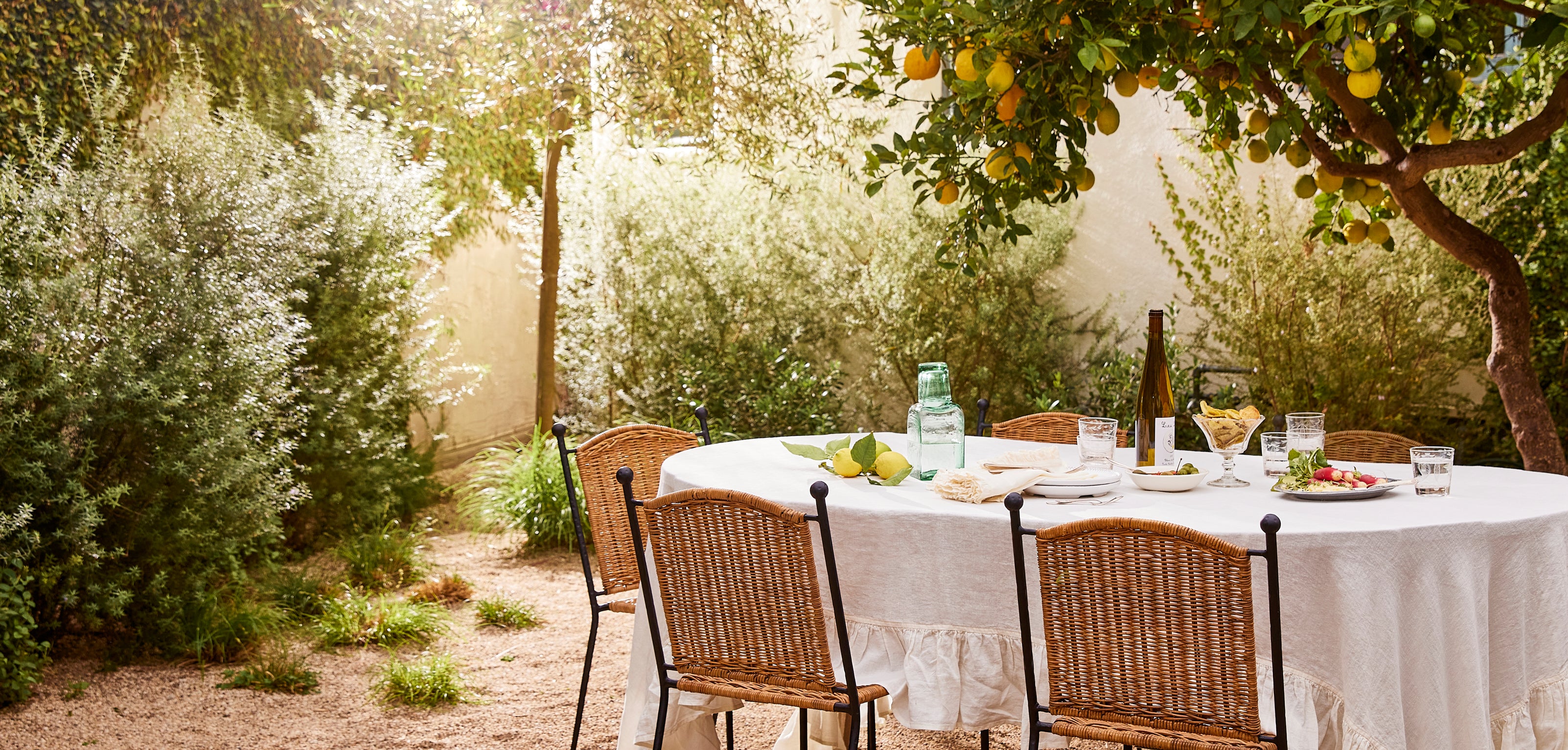 Outdoor dining table set with chairs in a garden setting