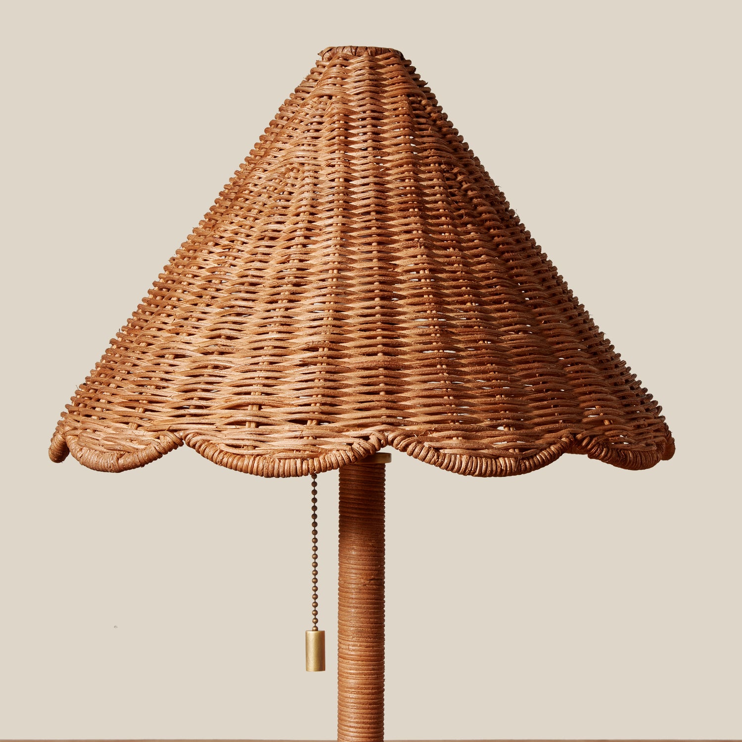 Wicker lamp with a pull chain on a beige background- Number 3