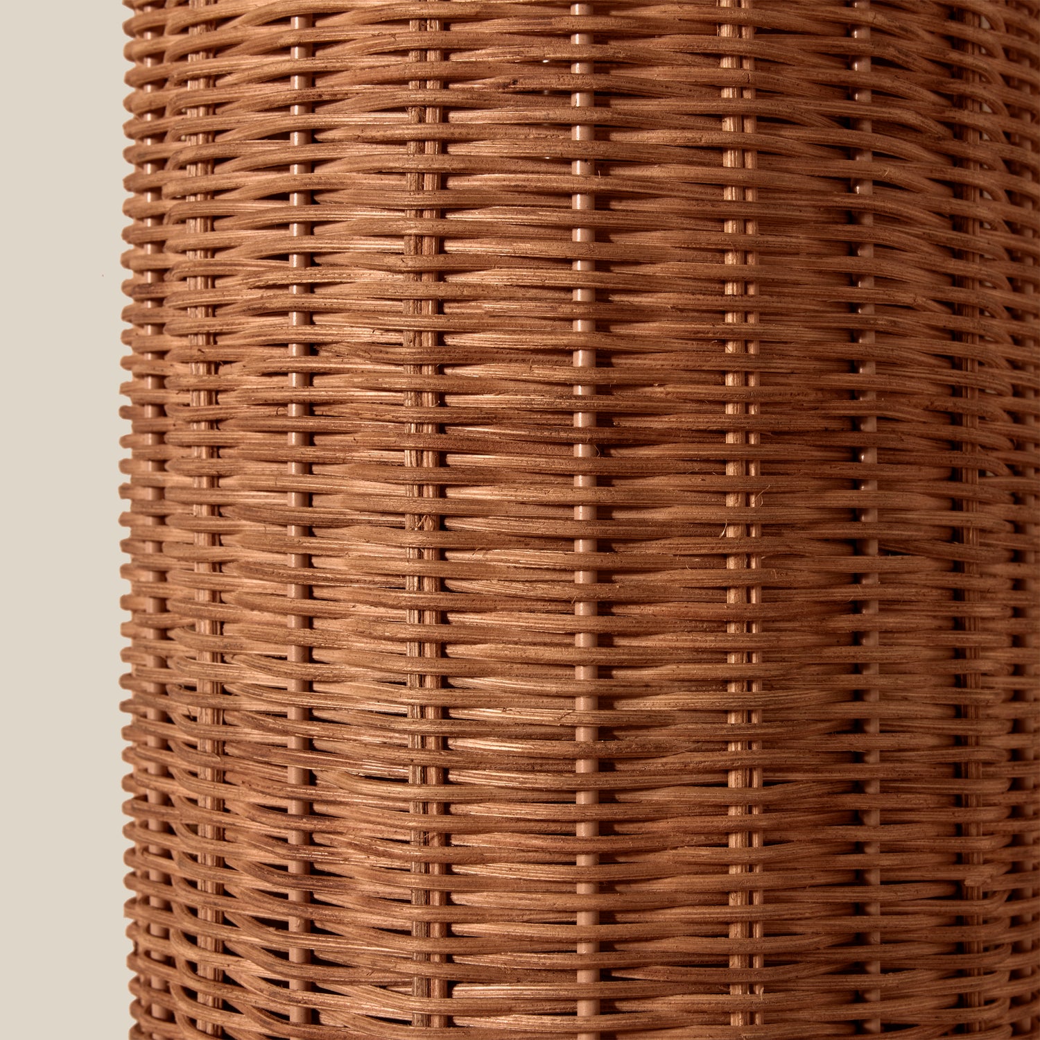 Close-up of a woven brown wall sconce on a beige background- Number 4