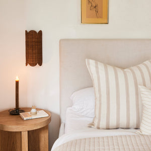 Bedroom with a bed, wooden side table, and wall art. - Number 2