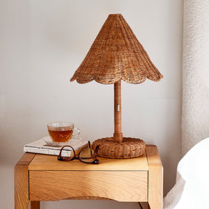 Wicker table lamp on a wooden side table with a cup and glasses against a neutral wall. - Number 2