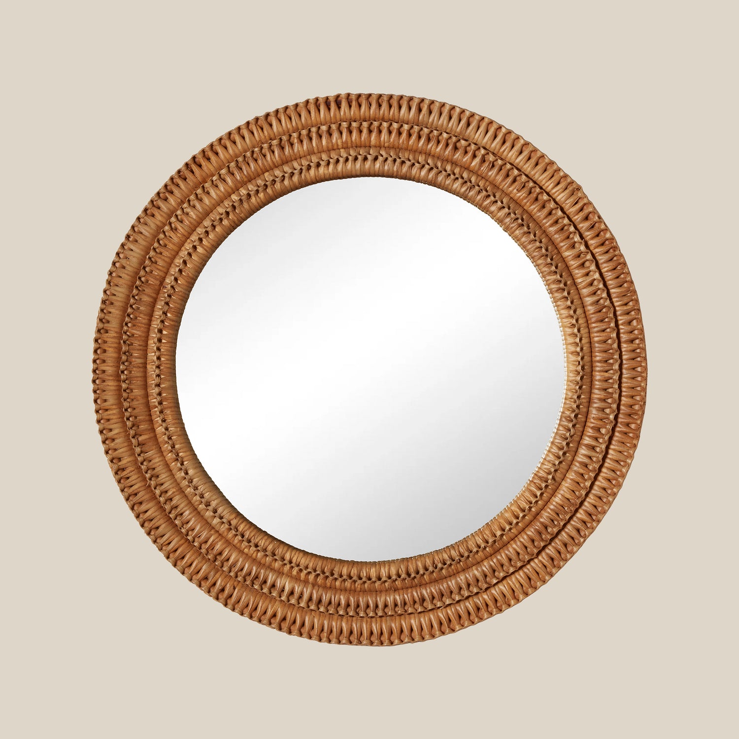 Round mirror with a woven wicker brown frame on a beige wall- Number 1