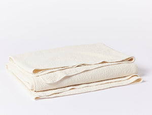 Folded beige towel on a white background - Number 1