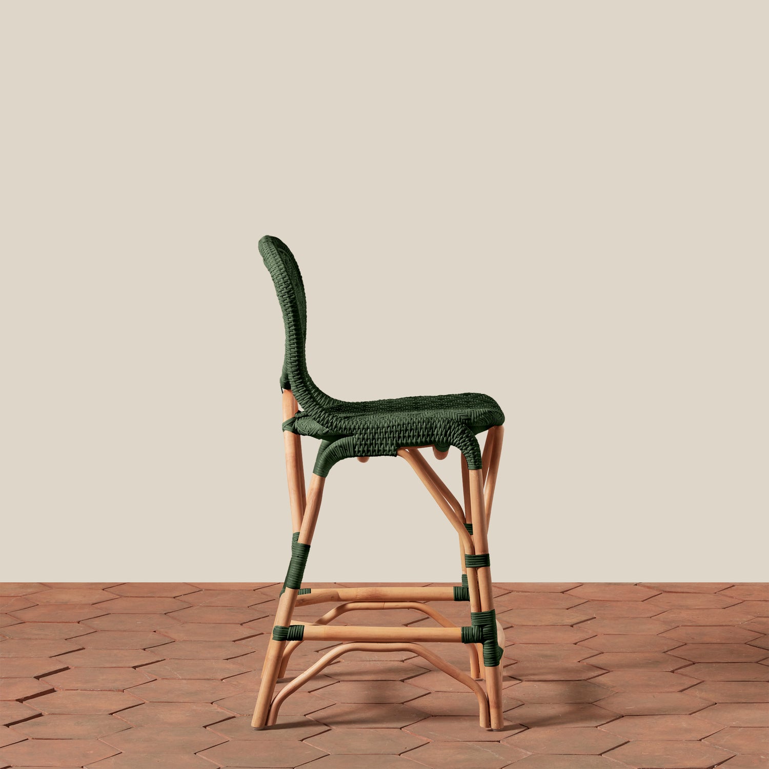 green counterstool in side view on tile floor and white background- Number 16