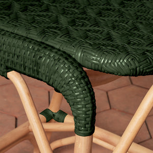 Close-up of a green wicker chair with wooden legs on a tiled floor. - Number 20