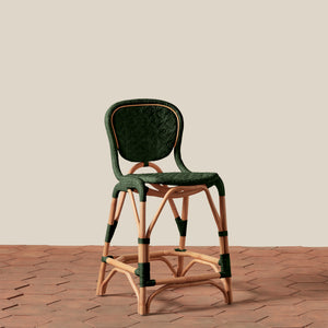Green bar stool with wooden legs on a beige background - Number 13