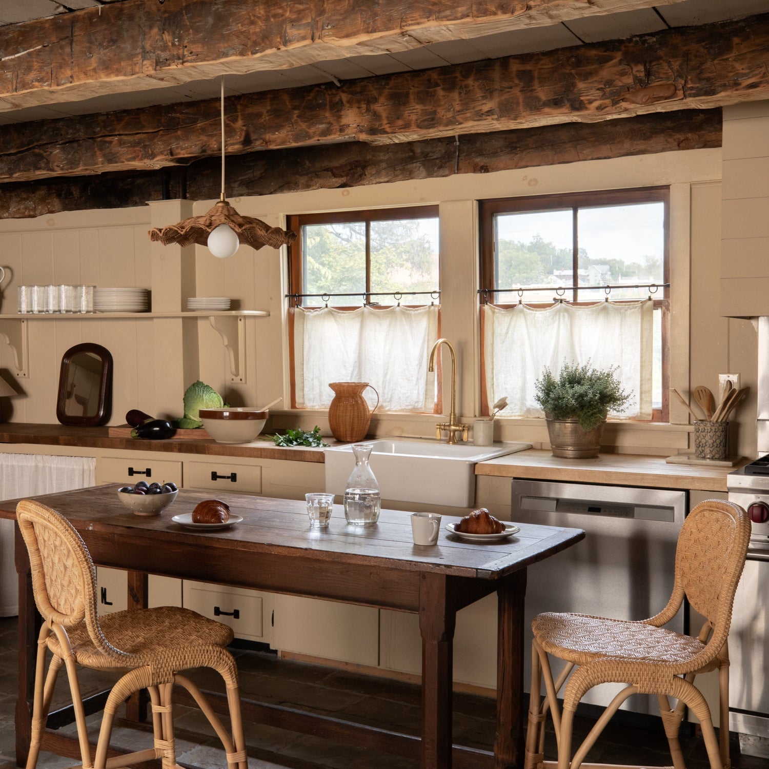 Kitchen with wooden table and chairs, rustic beams, and natural light.- Number 2