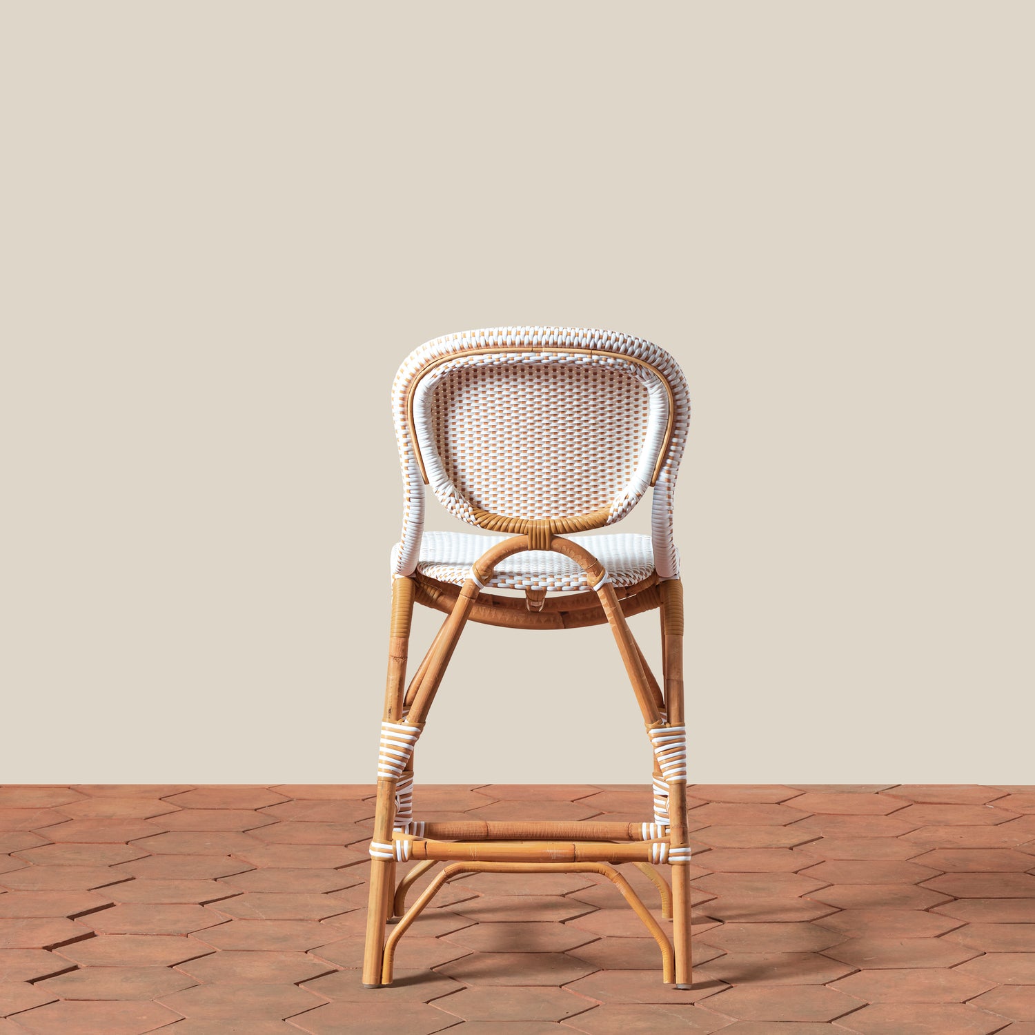 Wooden bar stool with wicker backrest on a wooden floor against a beige wall- Number 6
