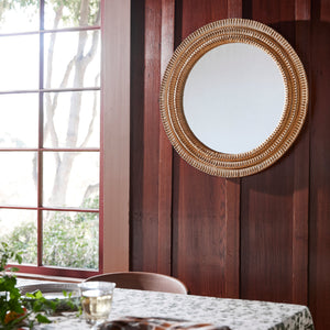 round mirror against dark wood wall - Number 2