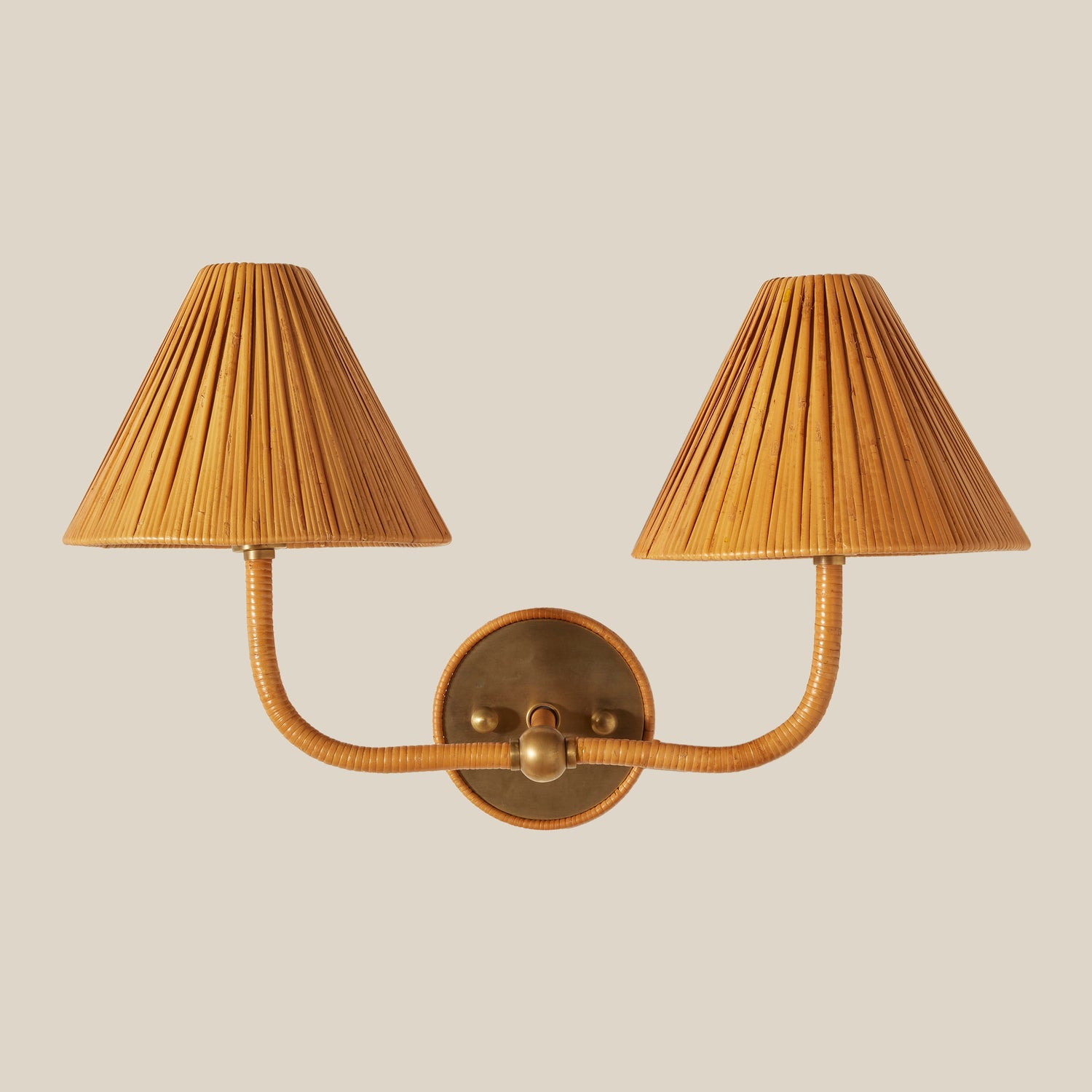 Rattan wall sconce with pleated lampshades on a beige background- Number 1