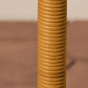 Tall, cylindrical lamp post with concentric rings on a brown background - Number 4