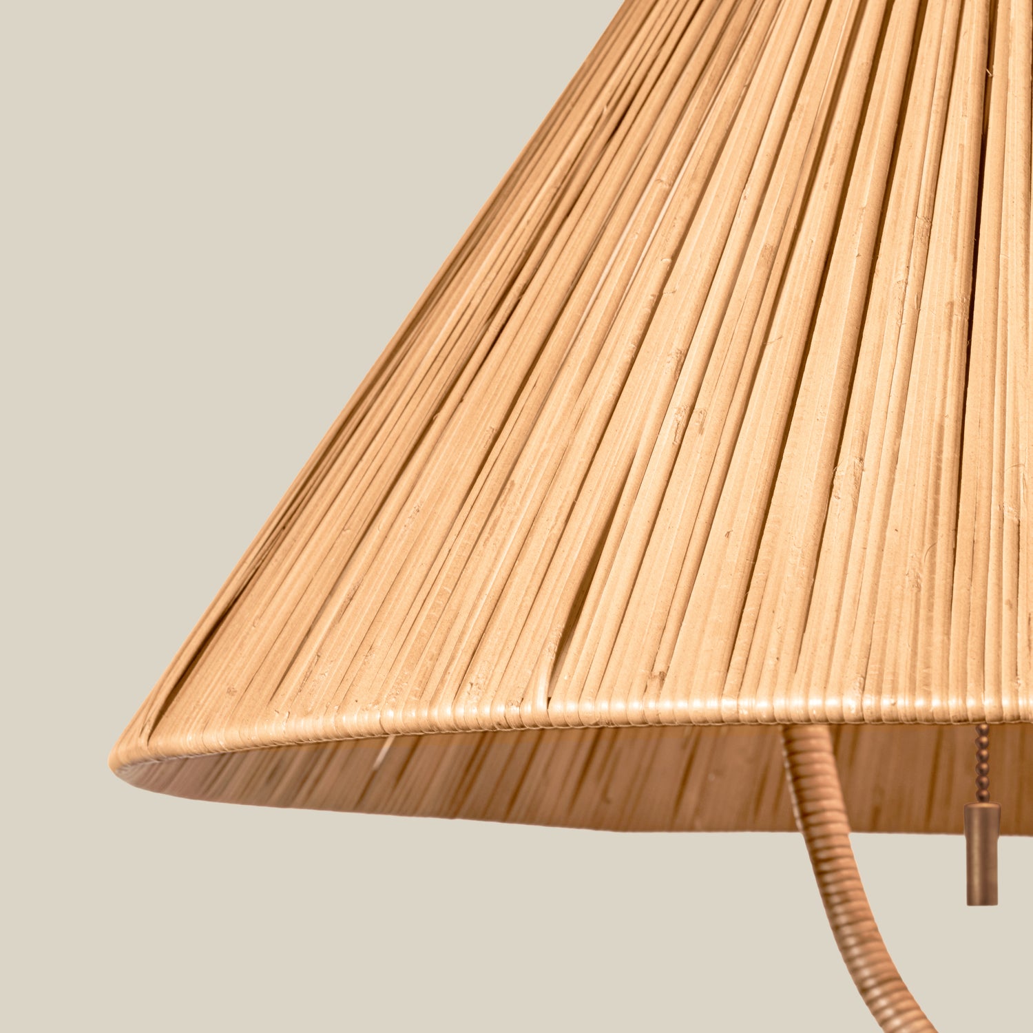 Closeup of a rattan lampshade against a neutral background- Number 4