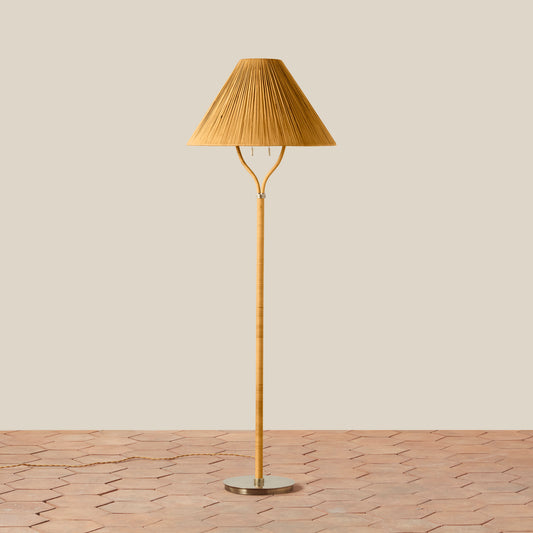 Brown floor lamp with pleated shade on a beige background