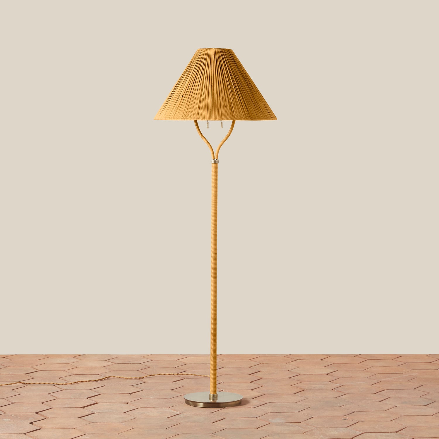 Brown floor lamp with pleated shade on a beige background- Number 1
