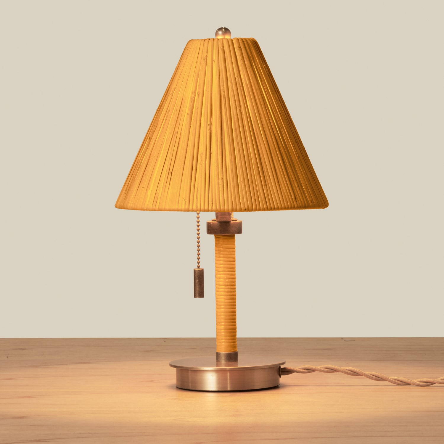 Table lamp with pleated brown shade on a wooden surface- Number 4