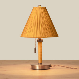 Table lamp with pleated brown shade on a wooden surface - Number 4